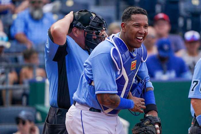 Jun 20, 2021; Kansas City, Missouri, USA; Kansas City Royals catcher Salvador Perez (13) laughs as he assures the umpires he s not hurt after getting hit with a foul tip in the seventh inning against the Boston Red Sox at Kauffman Stadium. Mandatory Credit: Denny Medley-USA TODAY Sports